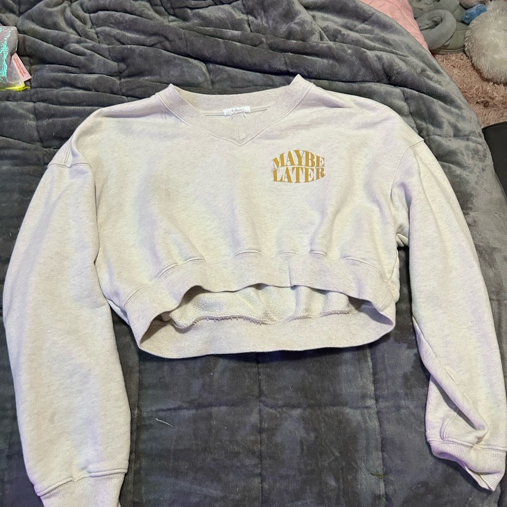 Trendy Cream Cropped Sweatshirt with Gold Text